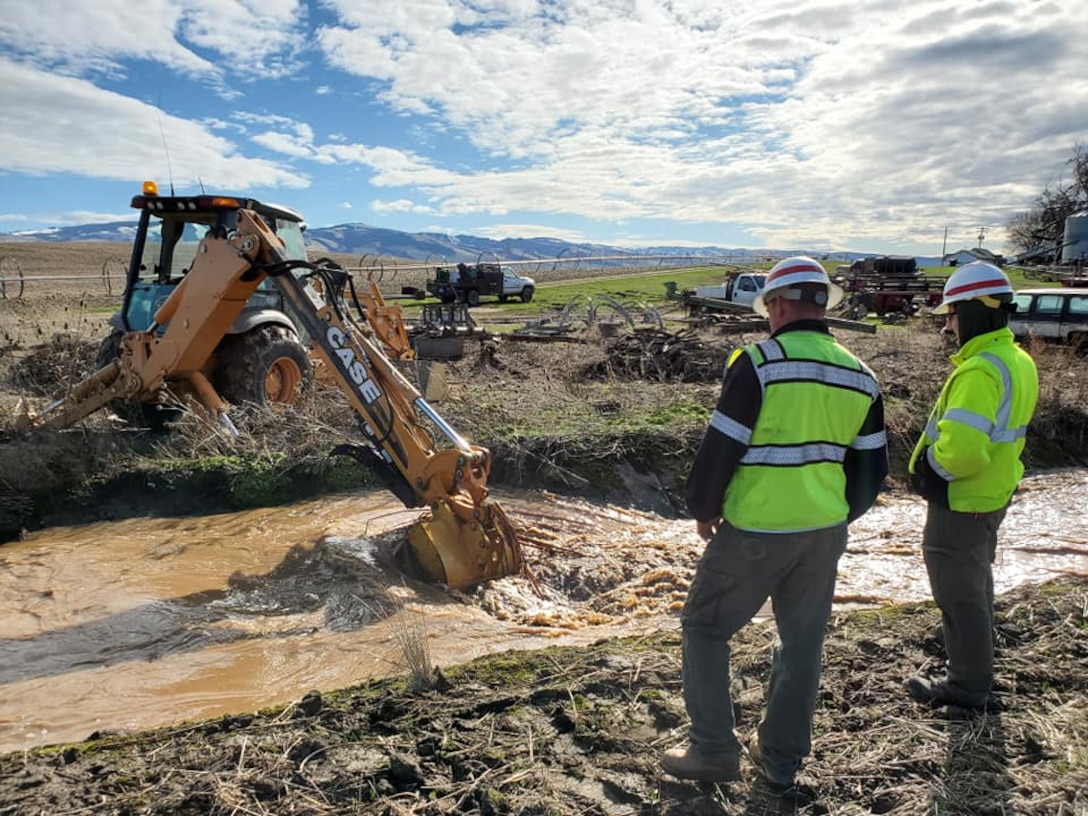 Project staff clearing debris from Russell Creek canal, Feb. 11.