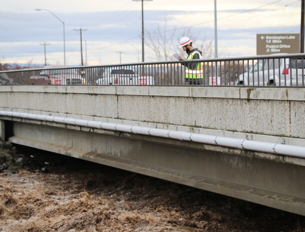 Corps official monitoring flows in the Mill Creek Channel.