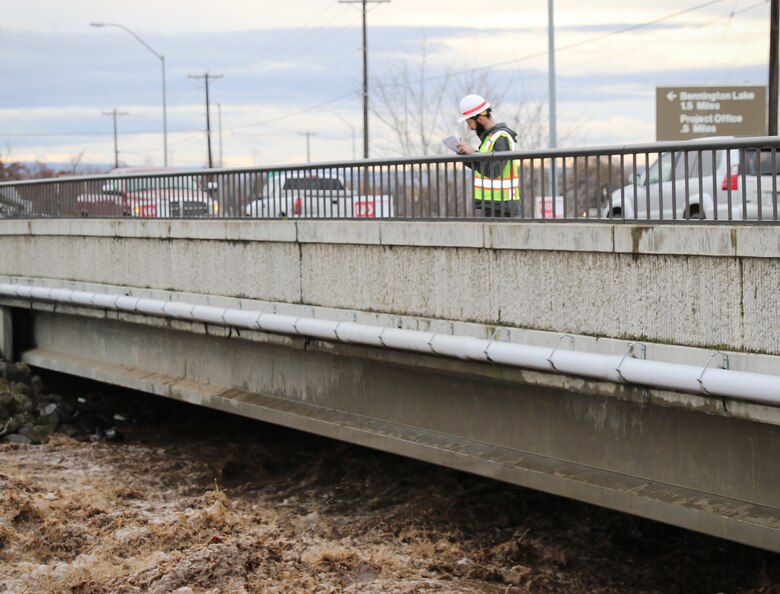 Corps official monitoring flows in the Mill Creek Channel.