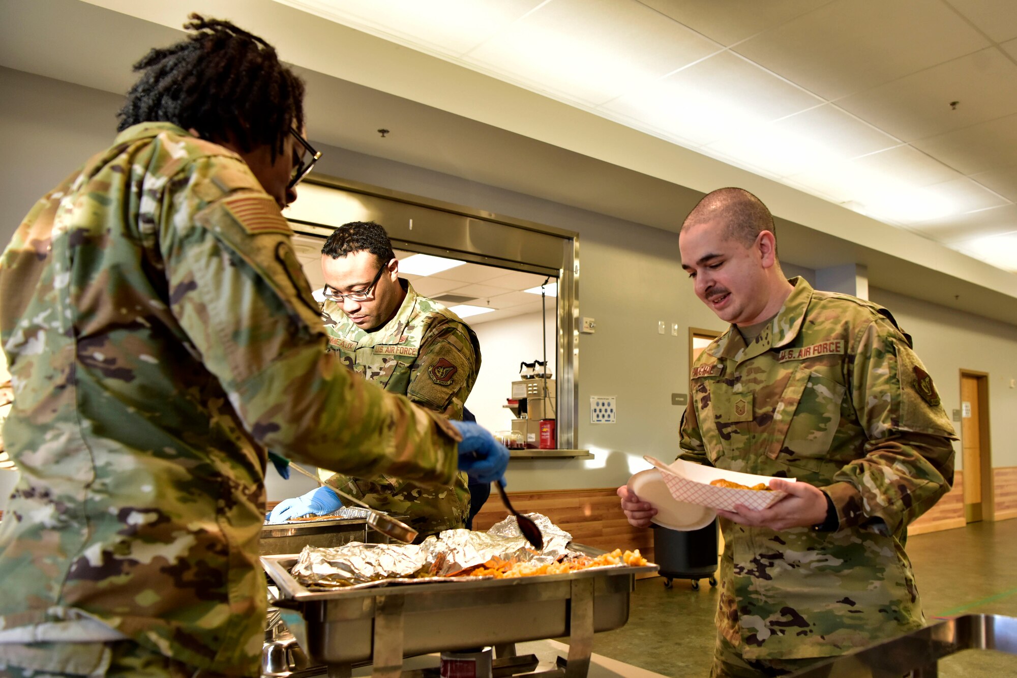 Airmen receive ethnic food at the A Taste of Culture event to celebrate Black History Month on Eielson Air Force Base, Alaska, Feb. 3, 2020. Yellow curry chicken, gumbo, red beans and rice were a few of the several dishes served at the event (U.S. Air Force photo by Senior Airman Beaux Hebert)