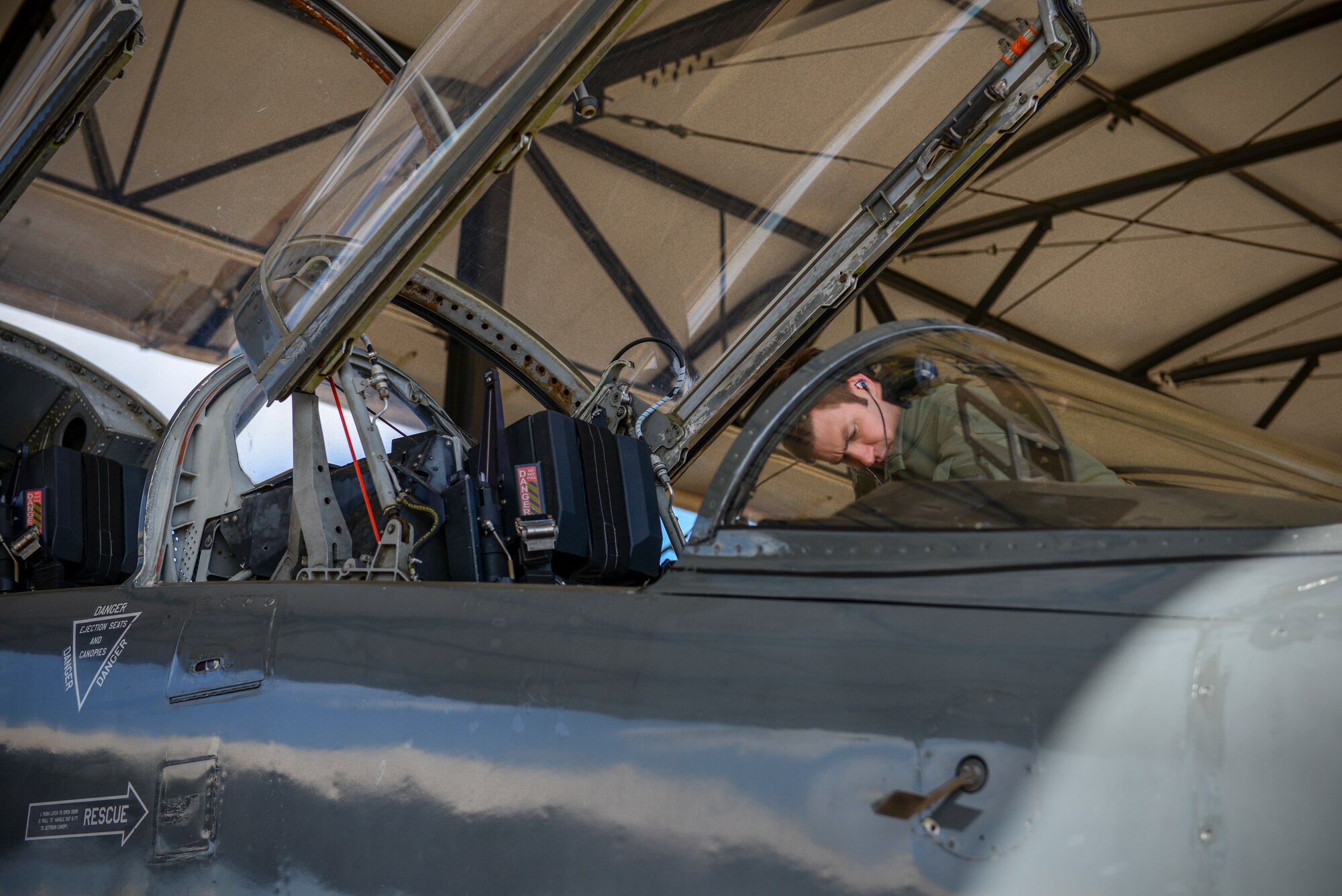 A 49th Fighter Training Squadron pilot examines the interior of a T-38 Talon Feb 7, 2020, on Columbus Air Force Base, Miss. The pilot participated in exercise Southern Strike. More than 40 units participated in or supported Southern Strike in 2020. (U.S. Air Force photo by Airman Davis Donaldson)