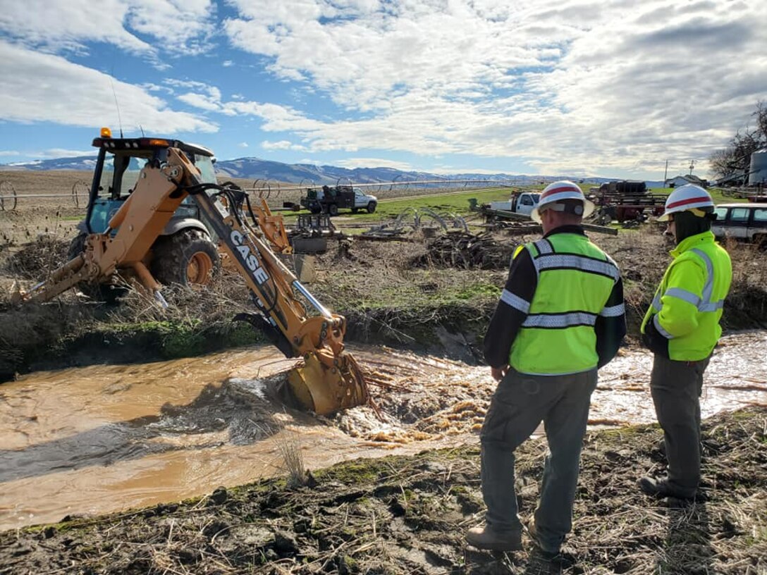 Project staff clearing debris from Russell Creek canal, Feb. 11.