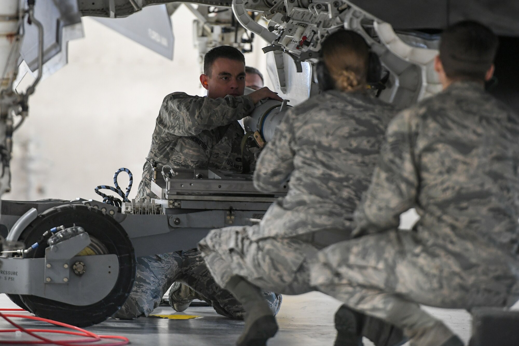 Airman loads an AIM-120 Advanced Medium-Range Air-to-Air Missile onto an F-35