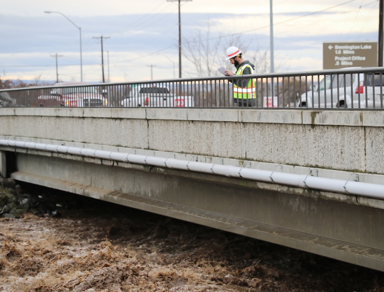 Corps official monitoring flows in the Mill Creek Channel.
