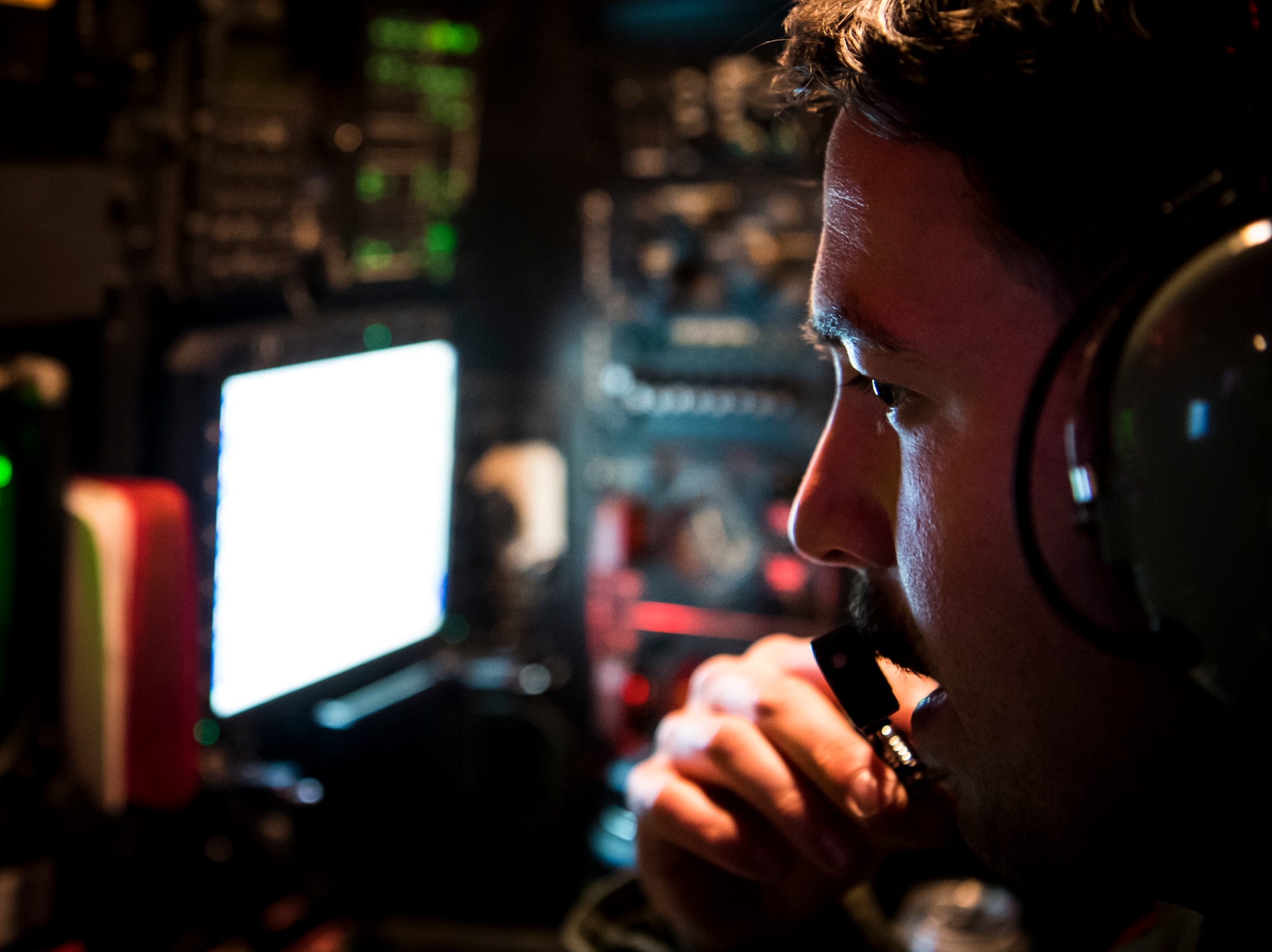 A U.S. Air Force weapon systems officer assigned to the 96th Bomb Squadron communicates with the other aircrew of a B-52H Stratofortress during Bomber Task Force Europe 20-1, Nov. 6, 2019 over the Barents Sea region of the Arctic Circle.  This deployment allows aircrews and support personnel to conduct theater integration and to improve bomber interoperability with joint partners and allied nations.  (U.S. Air Force photo by Airman 1st Class Duncan C. Bevan)