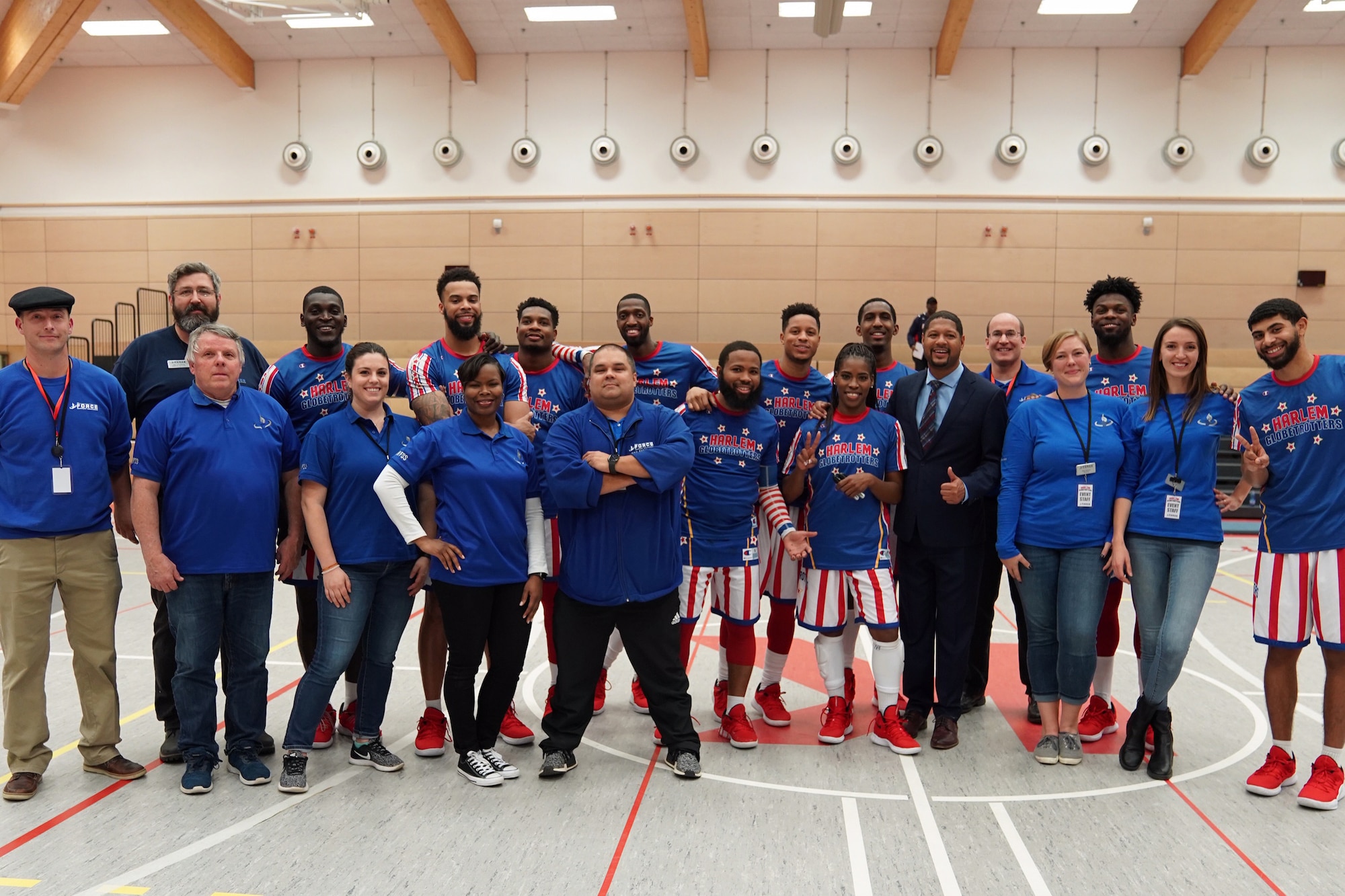 U.S. Air Force Lt. Col. Natosha Reed, 86th Force Support Squadron commander, front row, fourth from left, poses for a photo with the Harlem Globetrotters and other FSS team members during the Harlem Globetrotters Germany Tour in the Kaiserslautern High School at Kapaun Air Station, Germany, Nov. 15, 2019.