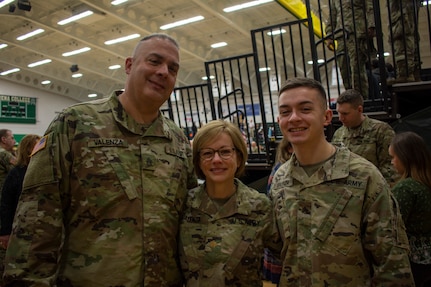 New York Army National Guard Sgt Andrew Valenza, right, joined by his parents, Maj. Julie Valenza and Sgt. 1st Class William Valenza, as they prepare to deploy together during the 42nd Infantry Division farewell ceremony Jan. 11, 2020, at Siena College in Loudonville, N.Y.  All five members of the Valenza family are serving. A son is already deployed in Afghanistan and a daughter is in the New York Army National guard as well.