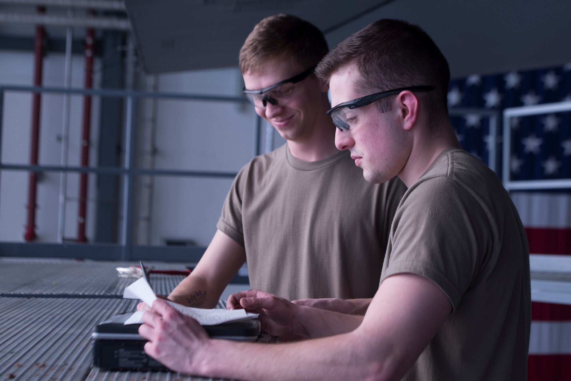 U.S. Air Force Airman 1st Class Zachary Treadwell, left, and Airman 1st Class Samuel Nemargut, 86th Maintenance Squadron aircraft structural maintenance journeymen, read instructions at Ramstein Air Base, Germany, Feb. 7, 2020. The instructions specifically list what aircraft part needs to be inspected for discrepancies and where it is located. The 86th MXS works around the clock to make sure the base’s C-130’s are well-maintained and ready to fly at all times.