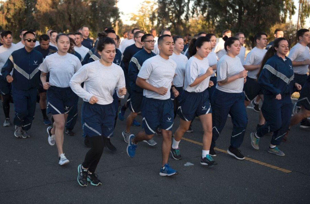 Airmen participating in group fitness exercises