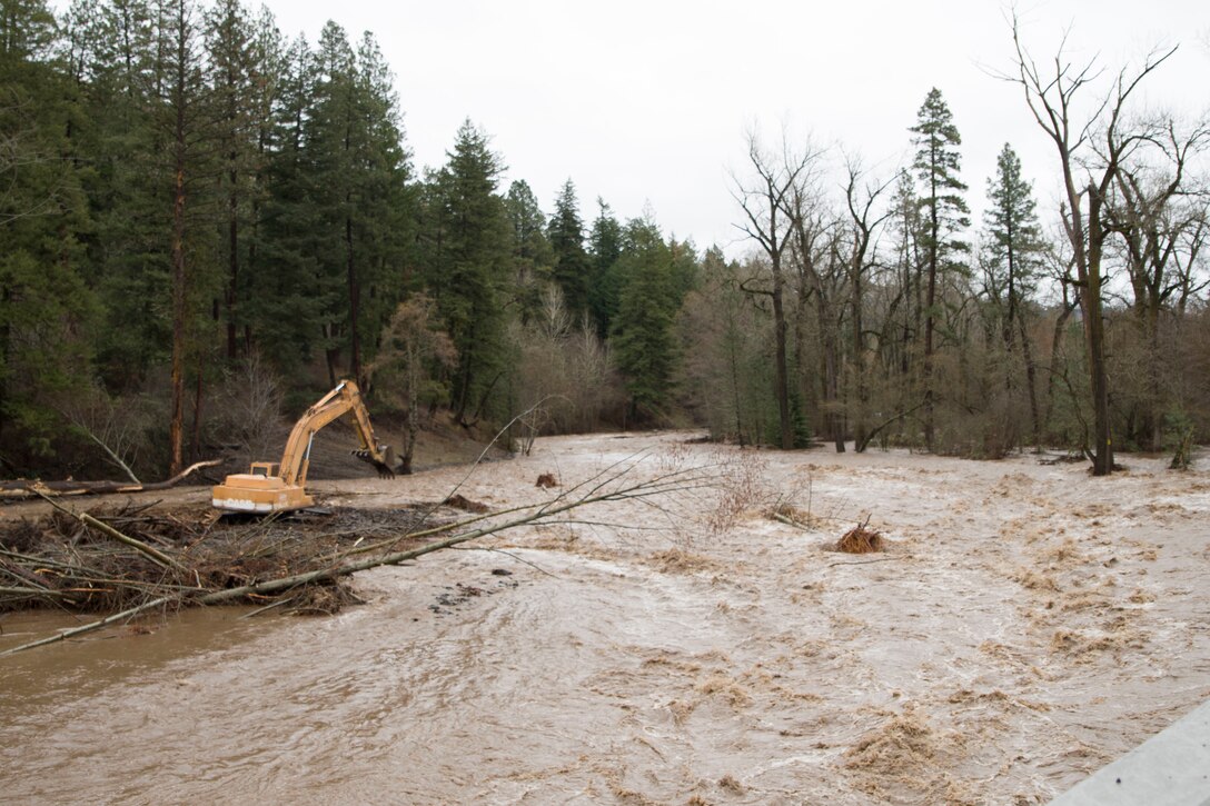 An excavator removes debris from the Mill Creek Channel.