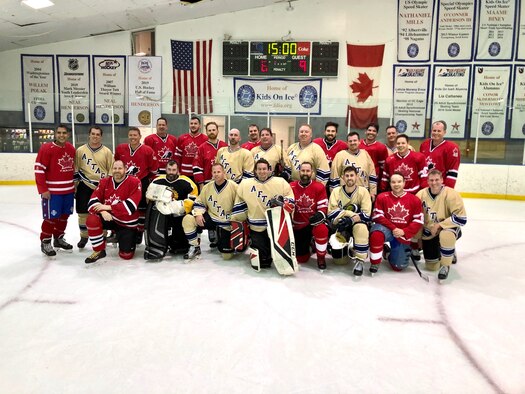Members of the Air Force Technical Applications Center and Canadian Embassy hockey teams pose for a post-game group photo Jan. 31, 2020 after the Florida-based AFTAC team traveled to Washington D.C., for a match-up against the Canadians based in the nation's capital.   (U.S. Air Force photo by Jason Nehmer)