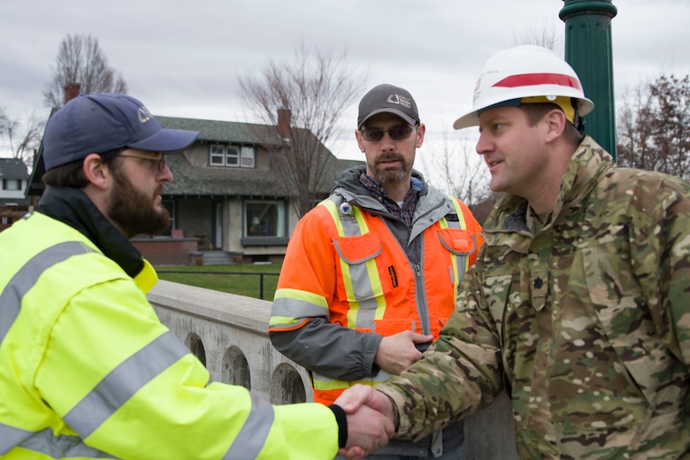 Lt. Col. Christian Dietz, Commander of the Walla Walla District Corps of Engineers greets Walla Walla City workers who are monitoring the Mill Creek Channel.