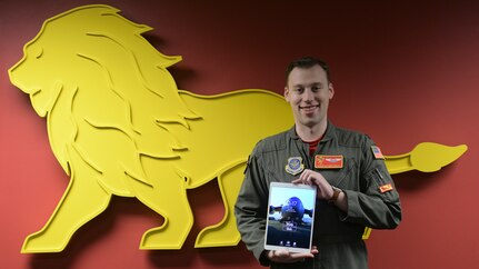 Capt. Christian Brechbuhl, an assistant flight commander assigned to the 16th Airlift Squadron, holds up a mobile device displaying an application he developed to help aircrews study for annual certifications at Joint Base Charleston, S.C., Feb. 7, 2020.  The application was cost-effectively developed by Airmen from multiple bases who volunteered their time to write the code. It centralized necessary study material for aircrew annual certification material and is currently being utilized by three airframes throughout Mobility Air Forces.