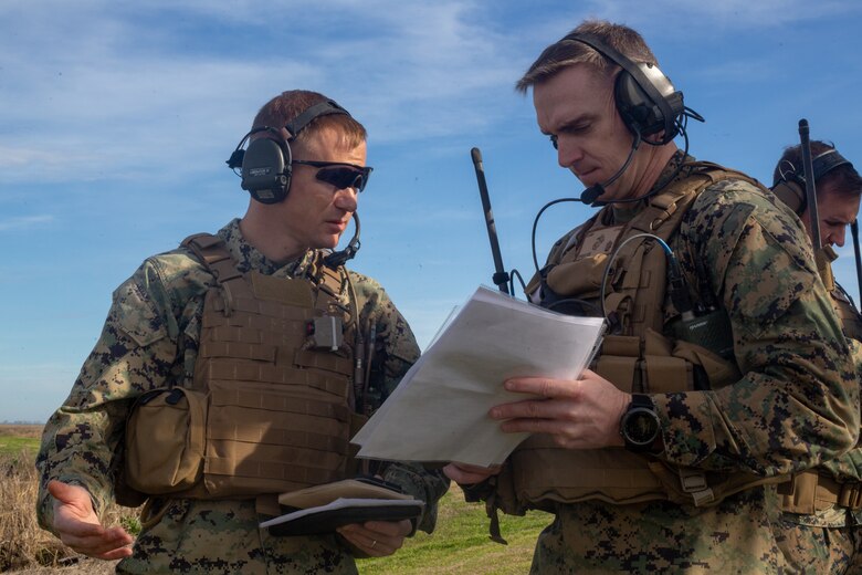 U.S. Marine Corps Master Sgt. Edwin Burch II, left, the assistant tactical air control party program manager with 1st Battalion, 10th Marine Regiment, 2nd Marine Division, and Maj. Steven Sprigg, an air officer with Headquarters Company, 2nd Marine Regiment, 2D MARDIV, coordinates a call for close air support during Exercise Fireball Eagle at Marine Corps Air Station Cherry Point, N.C., Feb. 4, 2020. The training consisted of multiple scenarios using aircraft and ground support fire to simulate real warfighting situations. (U.S. Marine Corps photo by Lance Cpl. Brian Bolin Jr.)