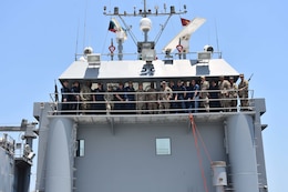 77th Sustainment Brigade command and the crew of the U.S. Army Vessel Molino Del Rey (LCU 2029) pose for photo, July 3, 2019, Camp Patriot, Kuwait. The crew of the U.S. Army Vessel Molino Del Rey (LCU 2029) performed maintenance and readiness battle drills in the Northern Arabian Gulf. Army watercraft are a crucial part of sustainment operations for the Army and the 77th Sustainment Brigade.