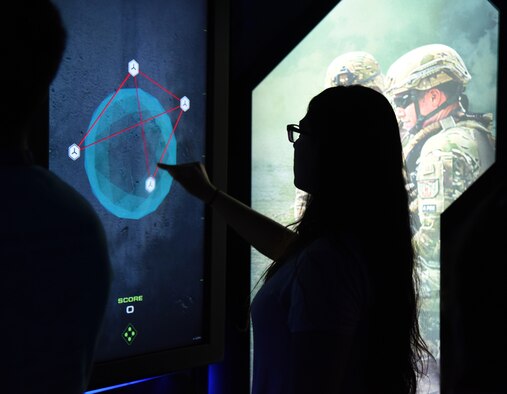 An attendee to Laughlin Air Force Base, Texas’ Fiesta of Flight interacts with a display wall May 12, 2018. White attending Laughlin Air Force Base, Texas’ 2020 Fiesta of Flight Air and Space expo, airshow-goers also have the opportunity to stop by the science, technology, engineering and mathematics displays on the flightline. (U.S. Air Force photo by Senior Airman Anne McCready)