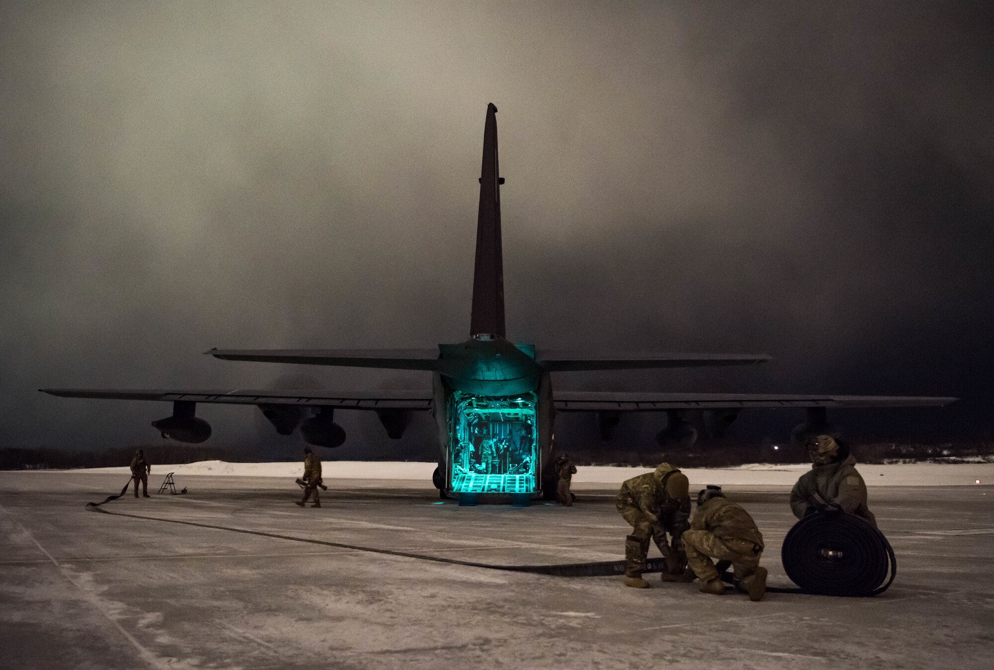 Airmen from Cannon Air Force Base’s 27th Special Operations Logistics Readiness Squadron forward area refueling point team work together to roll up a hose used for refueling during Emerald Warrior at Joint Base Elmendorf-Richardson, Alaska, Jan. 29, 2020. The main focus of Cannon’s participation in Emerald Warrior was to practice refueling F-22 Raptor aircraft from a MC-130J Commando II aircraft in austere arctic conditions. (U.S. Air Force Photo by Senior Airman Marcel Williams)