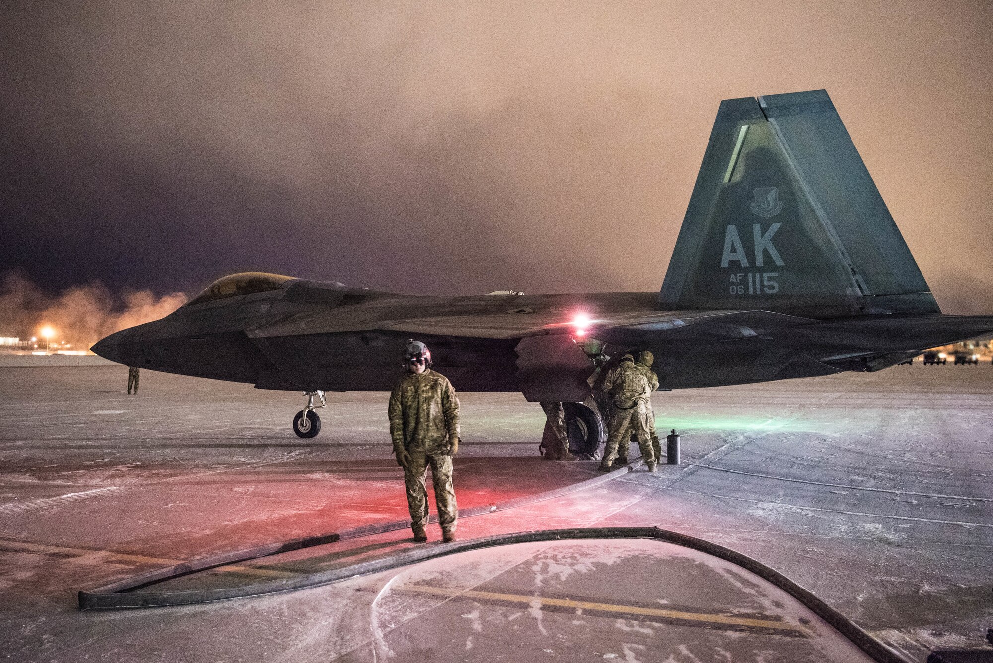 Airmen from Cannon Air Force Base’s 27th Special Operations Logistics Readiness Squadron forward area refueling point team refuel a F-22 Raptor aircraft during Emerald Warrior at Joint Base Elmendorf-Richardson flightline, Alaska, Jan.  29, 2020. Being able to execute this capability in these conditions marks a historic first for the United States Air Force. (U.S. Air Force Photo by Senior Airman Marcel Williams)