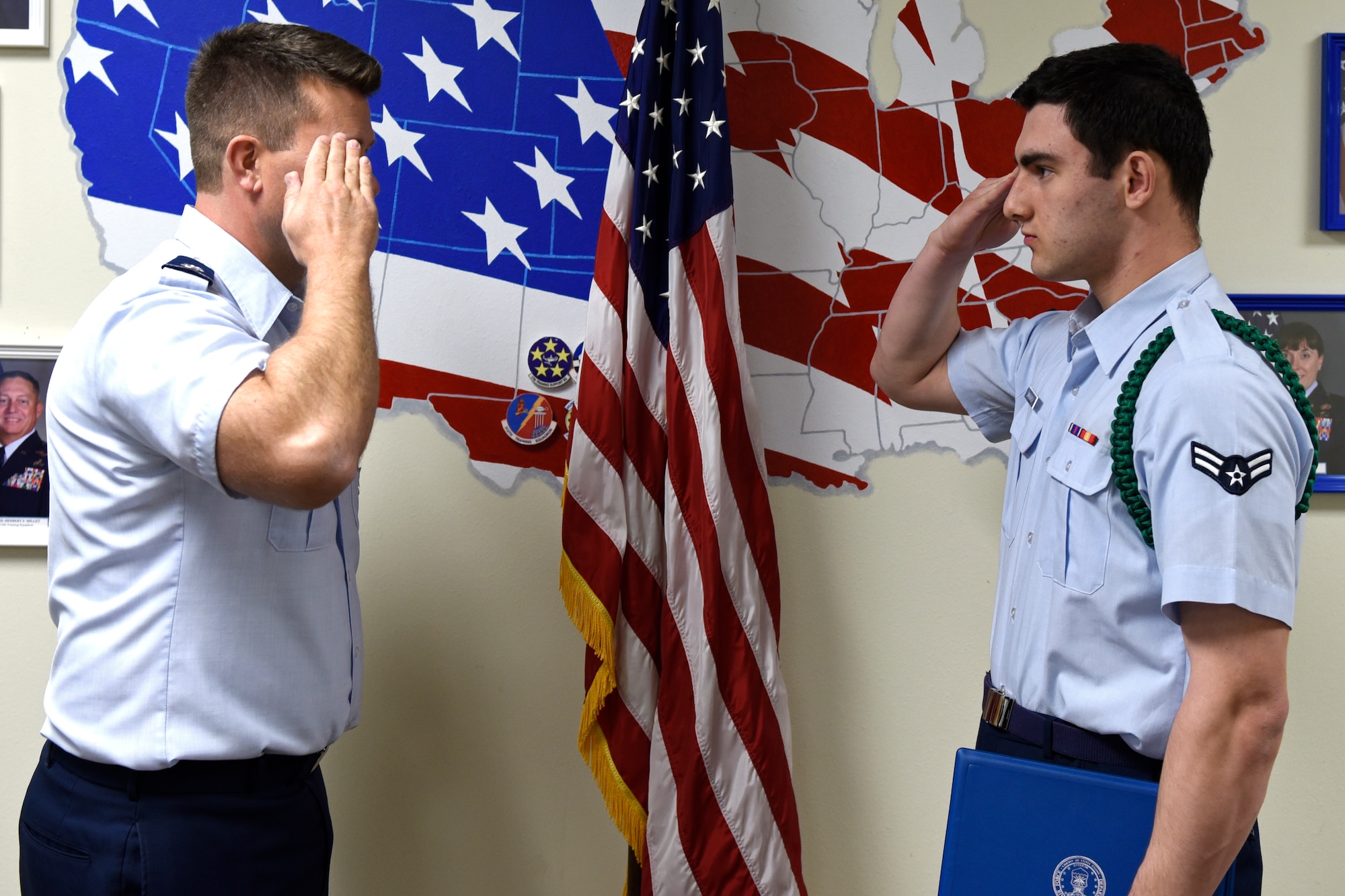 U.S. Air Force Lt. Col. Michael McCourt, 312th Training Squadron commander, salutes Airman 1st Class Nicolas Smaracheck, 315th Training Squadron student, after presenting him with the 17th Training Group Rope of the Month award at Brandenburg Hall on Goodfellow Air Force Base, Texas, Feb. 7, 2020. The green rope is the first of the leadership ropes, they are key players in keeping the order of a detachment. (U.S. Air Force photo by Airman 1st Class Zachary Chapman)