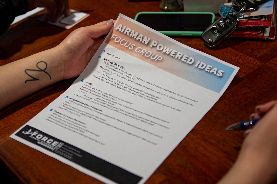 Photo of a focus group participant holding a flyer.