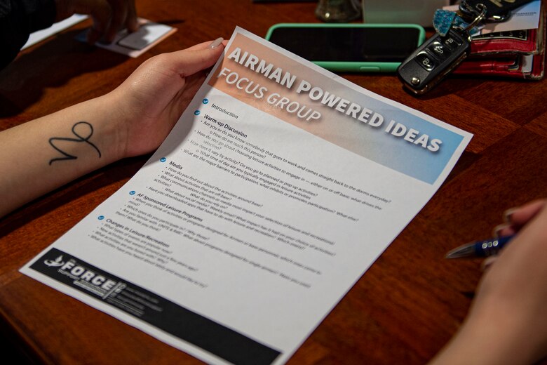 Photo of a focus group participant holding a flyer.