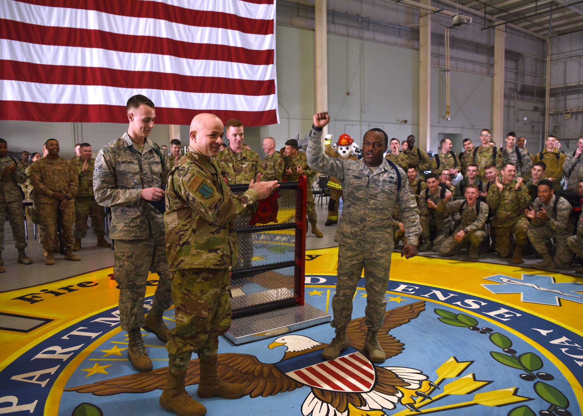 U.S. Air Force Col. Andres Nazario, 17th Training Wing commander, recognizes Tech. Sgt. Derwin Finley, 312th Training Squadron assistant flight chief and military training leader, as the winner of the Master MTL Program in the Louis F. Garland Department of Defense Fire Academy High Bay on Goodfellow Air Force Base, Texas, Feb. 7, 2020. Finley earned the first Master MTL position in the Air Education and Training Command history.  (U.S. Air Force photo by Airman 1st Class Abbey Rieves)