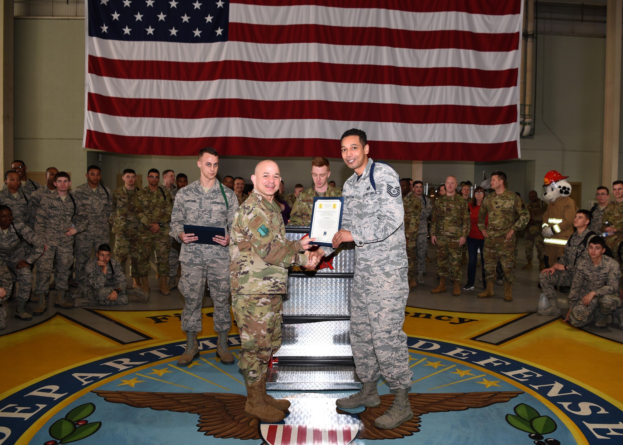 U.S. Air Force Col. Andres Nazario, 17th Training Wing commander, awards Tech. Sgt. Joseph Washington, 315th Training Squadron assistant flight chief and military training leader, as a Master MTL in the Louis F. Garland Department of Defense Fire Academy High Bay on Goodfellow Air Force Base, Texas, Feb. 7, 2020. As the first Master MTL position in the Air Education and Training Command history, new position comes with a higher standard to mentor, train and lead. (U.S. Air Force photo by Airman 1st Class Abbey Rieves)