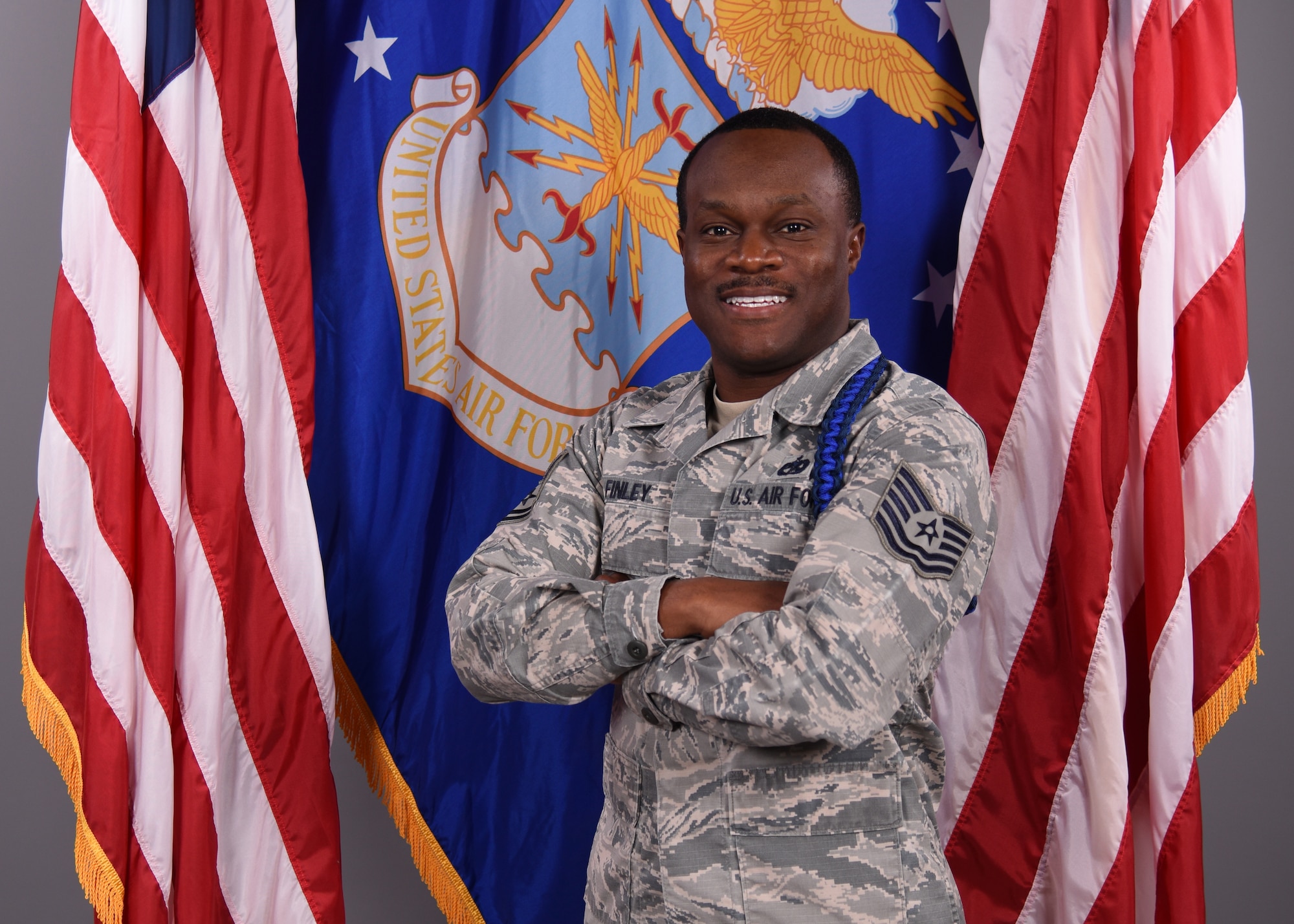 U.S. Air Force Tech. Sgt. Derwin Finley, 312th Training Squadron assistant flight chief and master military training leader, displays his new royal and dark blue colored aiguillette in the 17th Training Wing Public Affairs photo studio on Goodfellow Air Force Base, Texas, Feb. 12, 2020. The aiguillette physically distinguishes Finley as a beacon to mentor, train and lead not only technical training students, but other MTLs. (U.S. Air Force photo by Airman 1st Class Abbey Rieves)