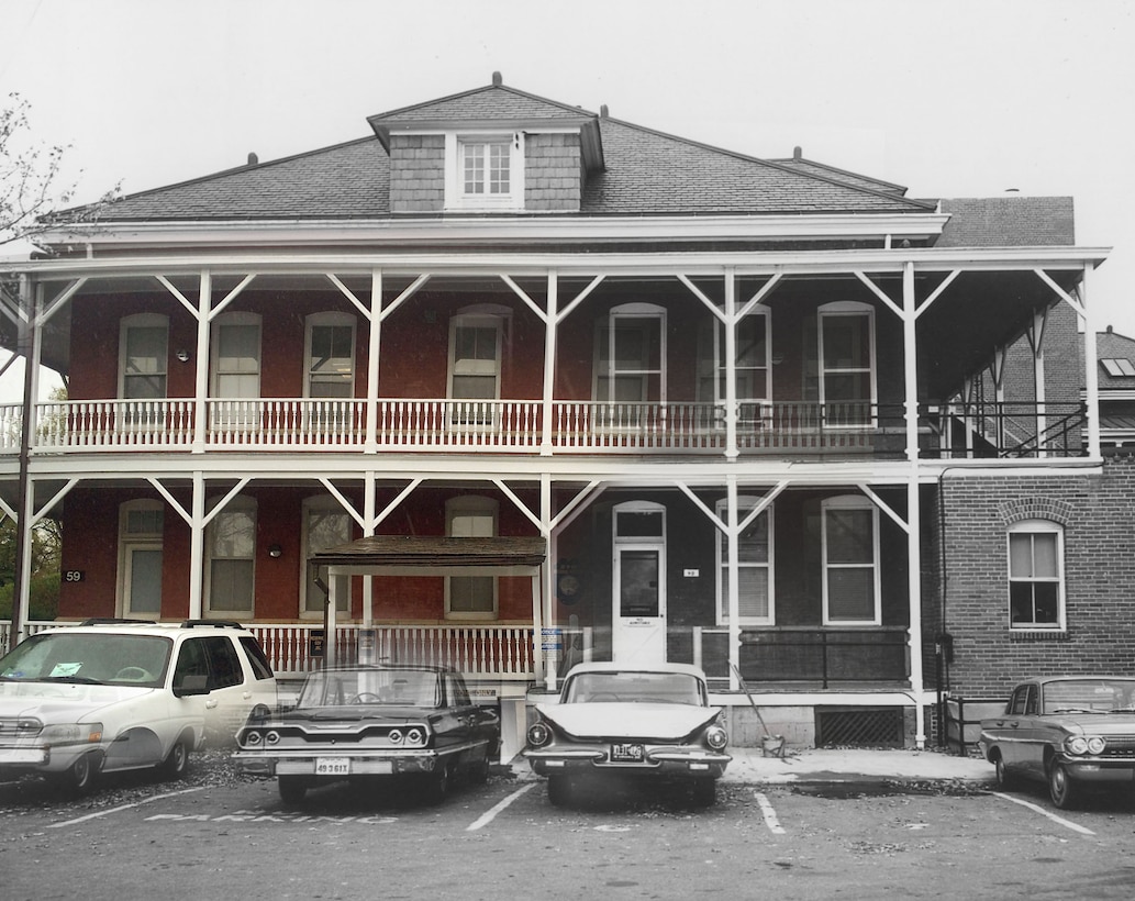 Buildings shown with parked cars.