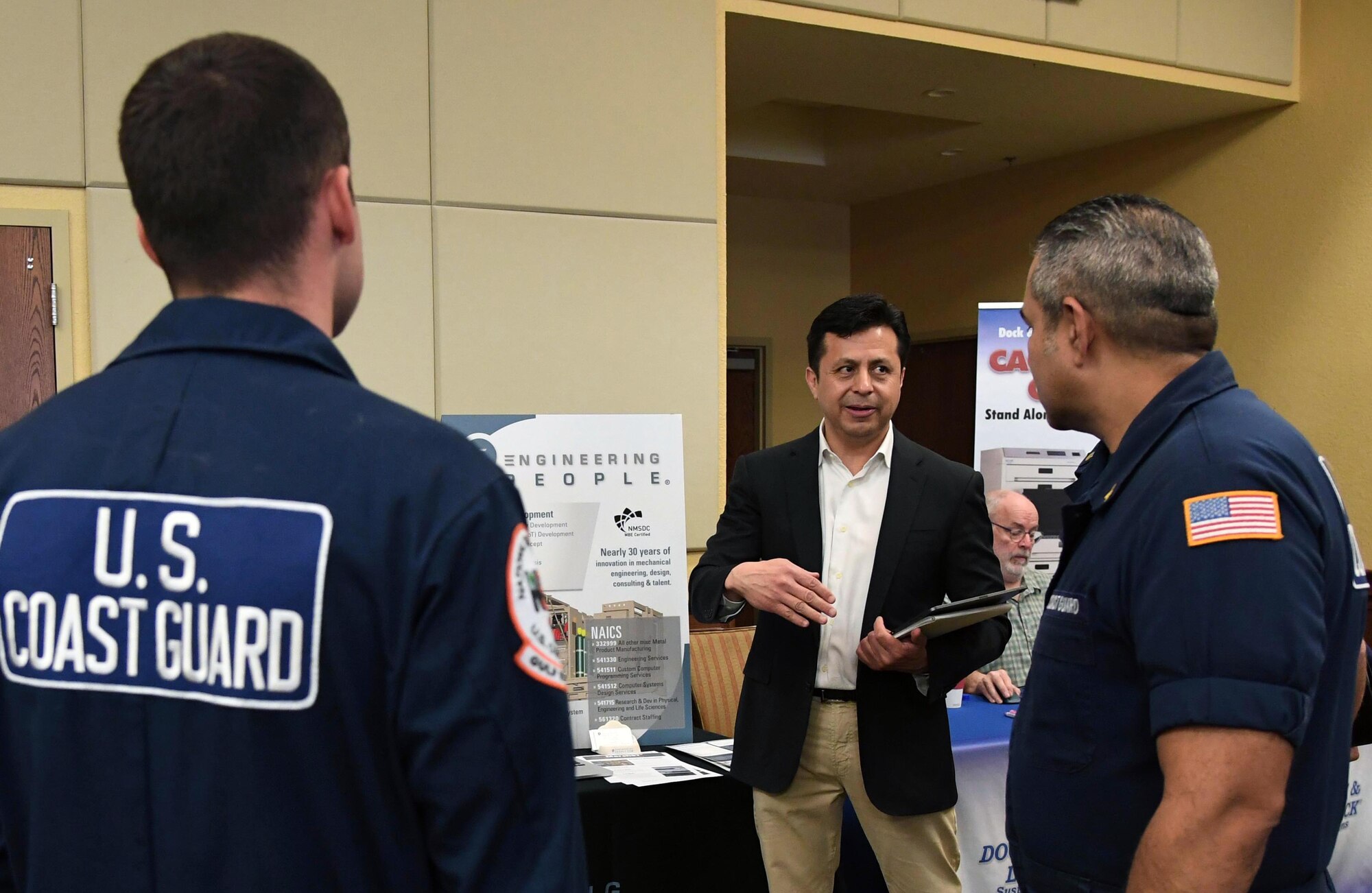 Jim Montelongo, Engineering People president and CEO, provides instruction on using virtual reality equipment for training to members of the U.S. Coast Guard Gulf Strike Team, Mobile, Alabama, during the Annual Keesler Air Force Base Tech Expo inside the Bay Breeze Event Center at Keesler Air Force Base, Mississippi, Feb. 11, 2020. The expo, hosted by the 81st Communications Squadron, was held to introduce military members to the latest in technological advancements to bolster the Air Force�s capabilities in national defense. (U.S. Air Force photo by Kemberly Groue)