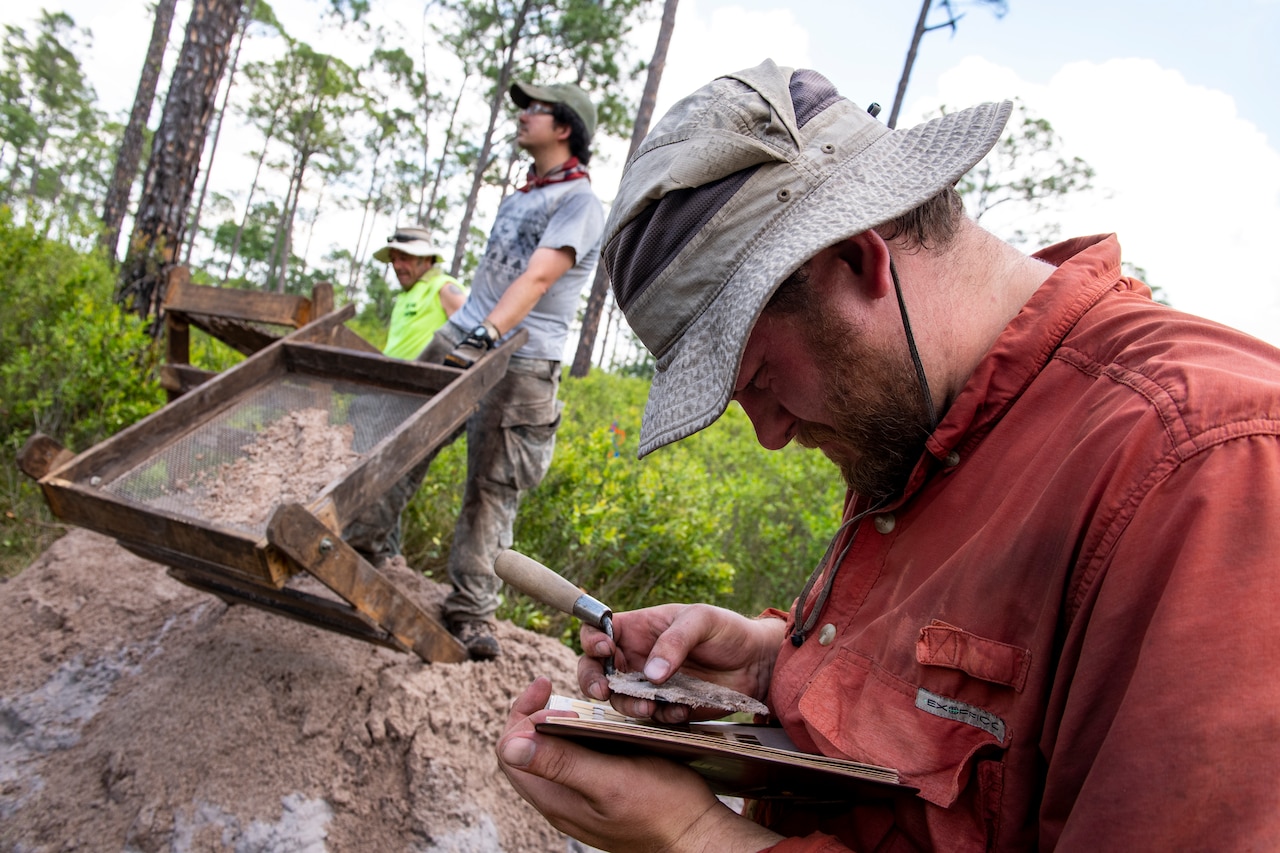 Men handle dirt.