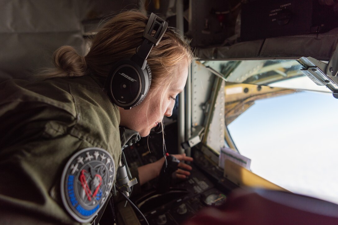 U.S. Air Force Staff Sgt. Samantha Grendahl, boom operator assigned to the 909th Air Refueling Squadron, communicates with a U.S. Navy F/A-18E Super Hornet pilot assigned to the Carrier Air Wing (CVW) 5 during exercise WestPac Rumrunner Jan. 10, 2020, out of Marine Corps Air Station Iwakuni, Japan. The exercise provided an opportunity for Kadena Airmen to practice a diverse array of capabilities in addition to working alongside joint partners in the Army, Navy and Marine Corps. (U.S. Air Force photo by Senior Airman Cynthia Belío)