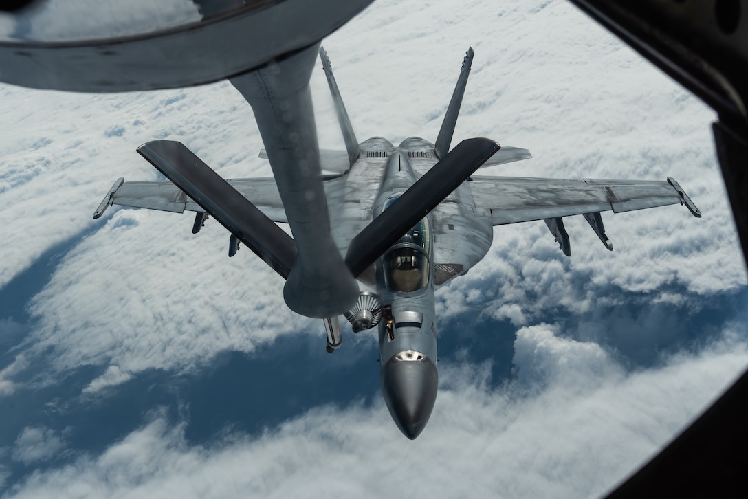 A U.S. Navy F/A-18E Super Hornet assigned to the Carrier Air Wing (CVW) 5 refuels with a KC-135 Stratotanker from the 909th Air Refueling Squadron during exercise WestPac Rumrunner Jan. 10, 2020, out of Marine Corps Air Station Iwakuni, Japan. The exercise brought Airmen and joint partners together to train and execute innovative ways to deploy forces in a contested environment. (U.S. Air Force photo by Senior Airman Cynthia Belío)