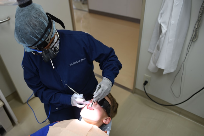 USAF dentist cleaning teeth