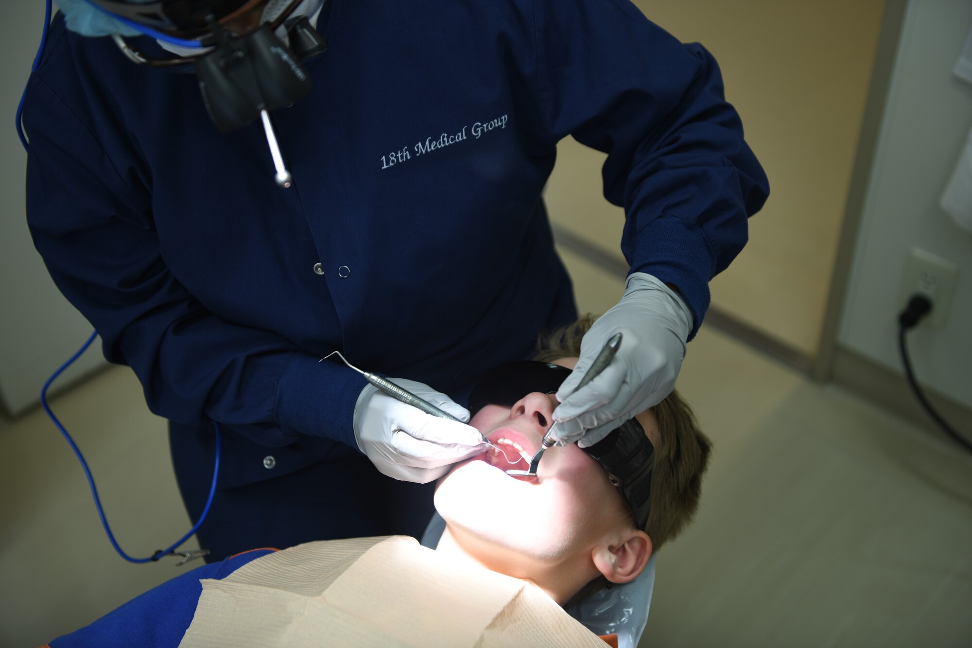 USAF dentist cleaning teeth