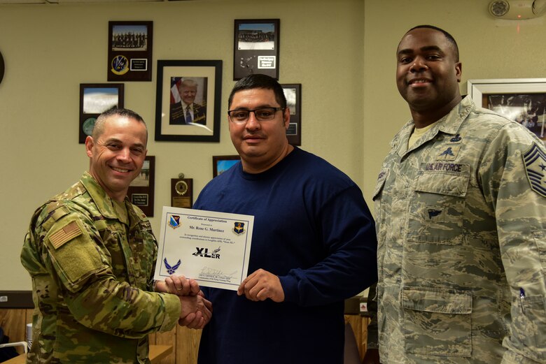Rene Martinez, a 47th Maintenance Squadron aircraft mechanic, was chosen by wing leadership to be the “XLer” of the Week, Feb. 3, 2020, at Laughlin Air Force Base, Texas. The “XLer” award, presented by Col. Lee Gentile, 47th Flying Training Wing commander, and Chief Master Sgt. Robert L. Zackery III, 47th FTW command chief master sergeant, is given to those who consistently make outstanding contributions to their unit and the Laughlin mission. (U.S. Air Force photo by Senior Airman Anne McCready)