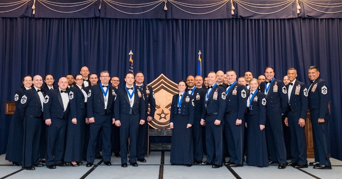 Chief master sergeants and chief master sergeant selects pose for a photo at the conclusion of the Chief Master Sergeant Recognition Ceremony at the Landings, Feb. 8, 2020, on Dover Air Force Base, Del. Eleven senior master and chief master sergeants were honored for their achievement. Chief Master Sgt. Terrence Greene, Air Mobility Command command chief, Scott AFB, Ill., was the guest speaker for the event. (U.S. Air Force photo by Roland Balik)