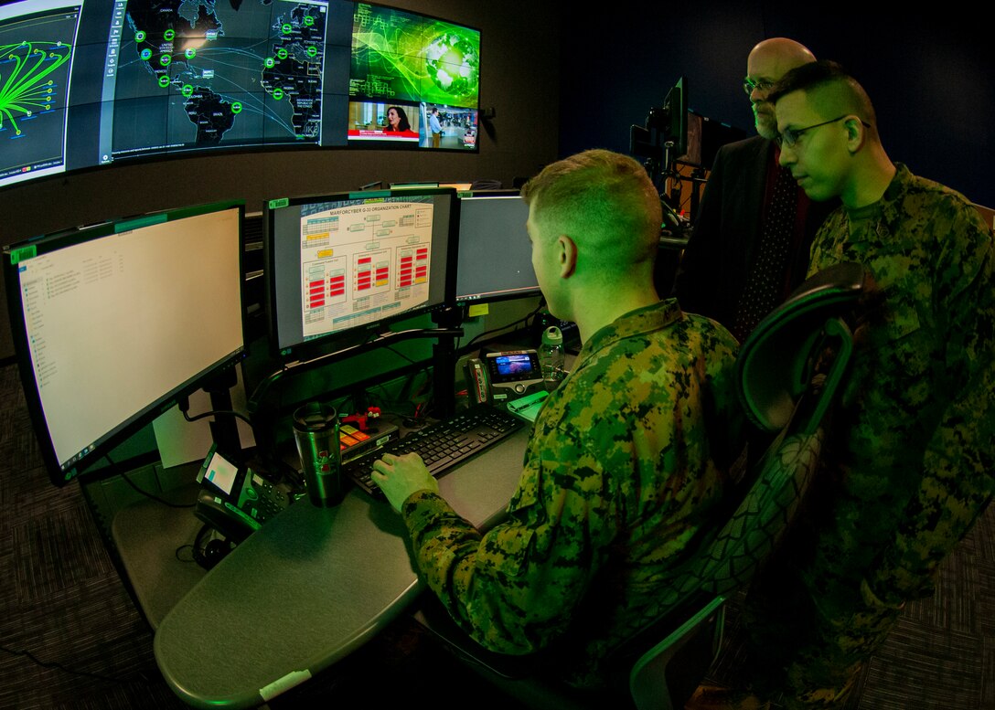 Marines with Marine Corps Forces Cyberspace Command pose for photos in the cyber operations center at Lasswell Hall aboard Fort Meade, Maryland, Feb. 5, 2020. MARFORCYBER Marines conduct offensive and defensive cyber operations in support of United States Cyber Command and operate, secure and defend the Marine Corps Enterprise Network.