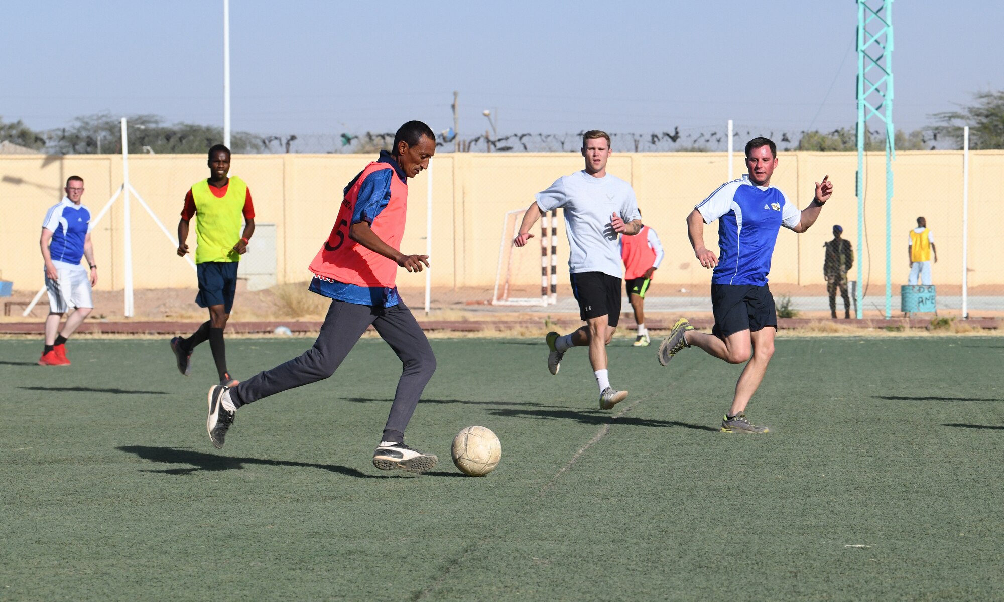 Photo of U.S. military and local team playing soccer.