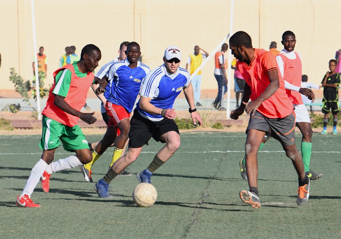 Photo of U.S. military and local team playing soccer.