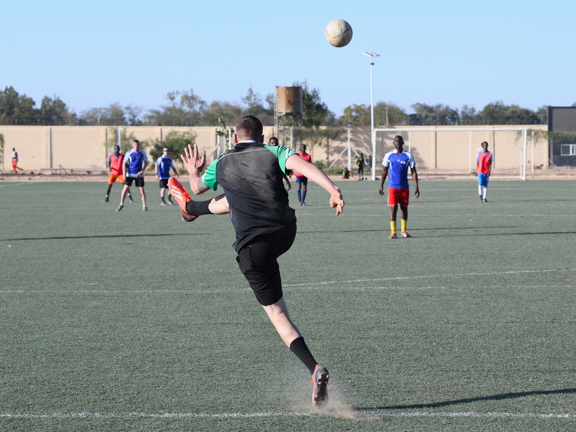 Photo of U.S. military and local team playing soccer.