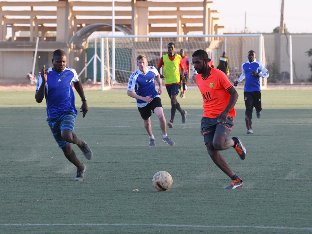 Photo of U.S. military and local team playing soccer.