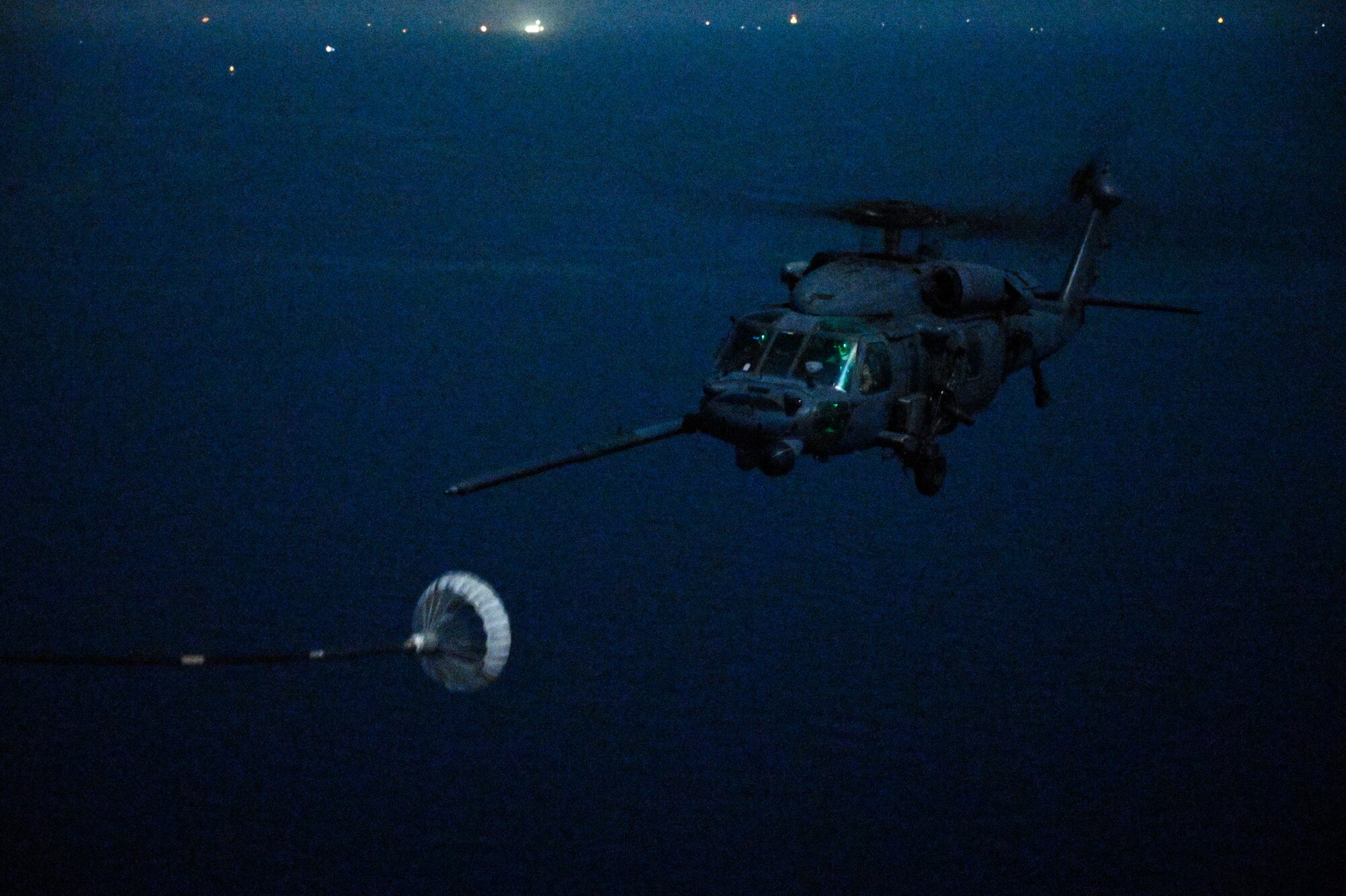 A U.S. Air Force HH-60G Pave Hawk, assigned to the 66th Expeditionary Rescue Squadron deployed to Al Udeid Air Base, Qatar, conducts a helicopter in-air refueling over the Arabian Gulf with a U.S. Air Force HC-130J Combat King II, assigned to the 79th ERQS deployed to Al Udeid AB, Feb. 6, 2020.