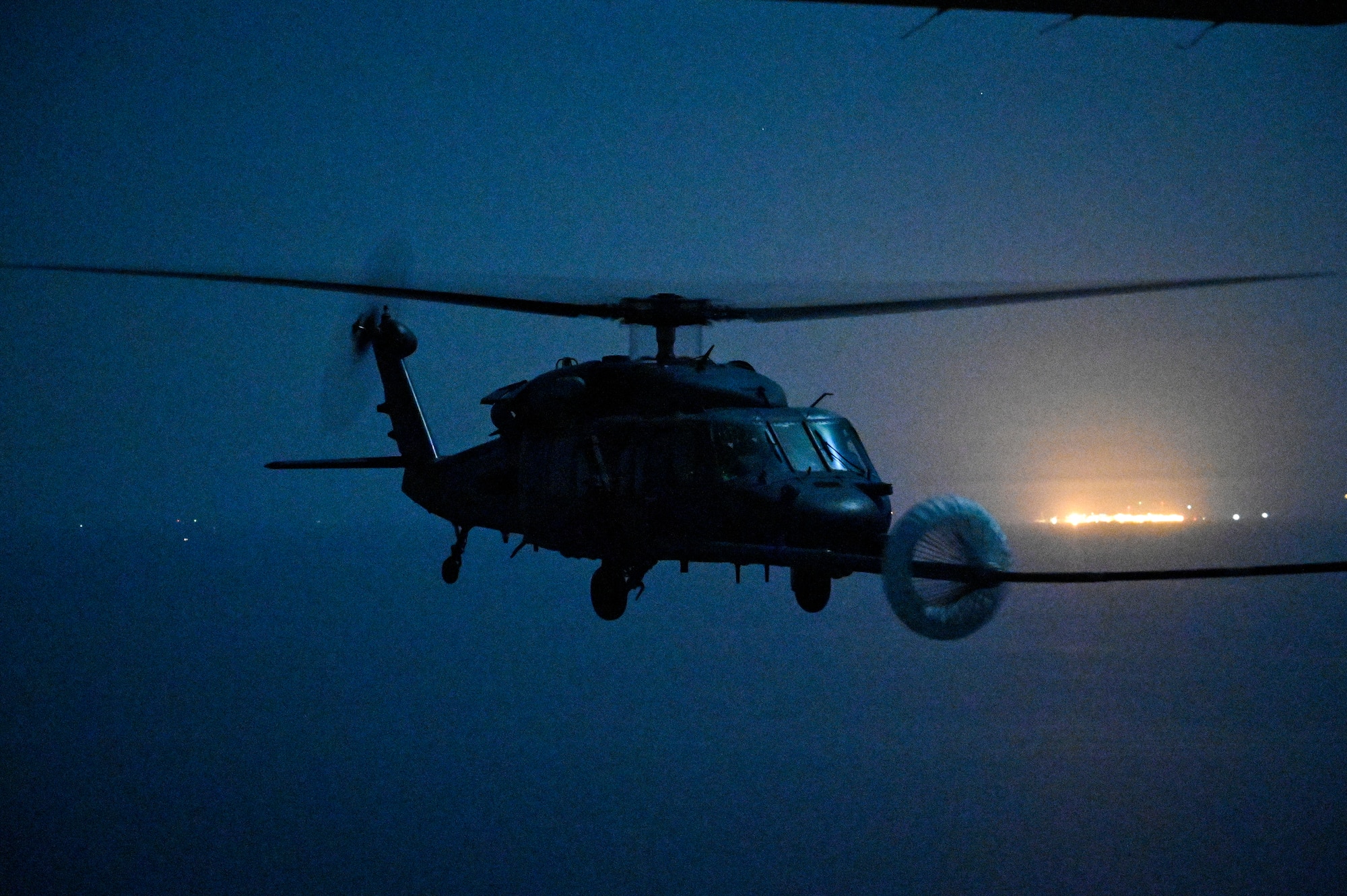 A U.S. Air Force HH-60G Pave Hawk, assigned to the 66th Expeditionary Rescue Squadron deployed to Al Udeid Air Base, Qatar, conducts a helicopter in-air refueling over the Arabian Gulf with a U.S. Air Force HC-130J Combat King II, assigned to the 79th ERQS deployed to Al Udeid AB, Feb. 6, 2020.