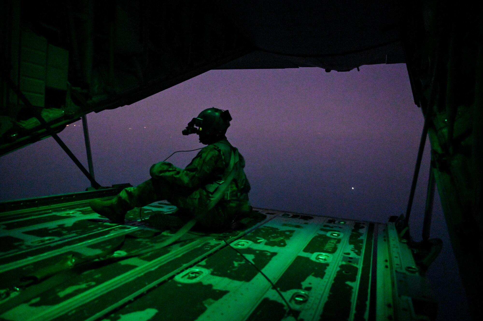 A U.S. Air Force HC-130J Combat King II loadmaster with the 79th Expeditionary Rescue Squadron, deployed to Al Udeid Air Base, Qatar, observes airspace during a personnel recovery training mission over the Arabian Gulf, Feb. 6, 2020.