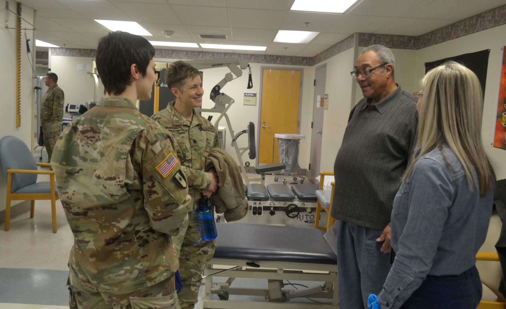 DLA Troop Support military personnel speak with a patient and his physical therapist at the Corporal Michael J. Crescenz Veterans Affairs Medical Center, Feb. 10, 2020 in Philadelphia.