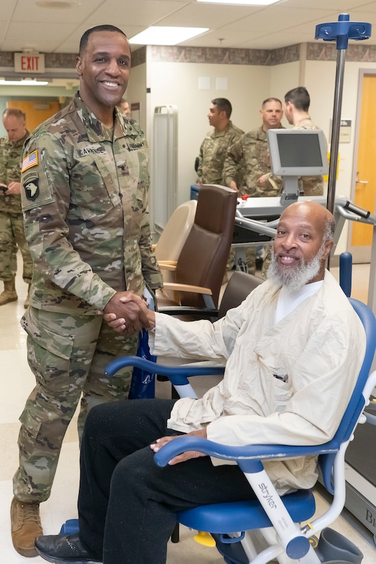 Army Brig. Gen. Gavin Lawrence, DLA Troop Support Command, shakes hands with a veteran patient at the Corporal Michael J. Crescenz Veterans Affairs Medical Center, Feb. 10, 2020 in Philadelphia.