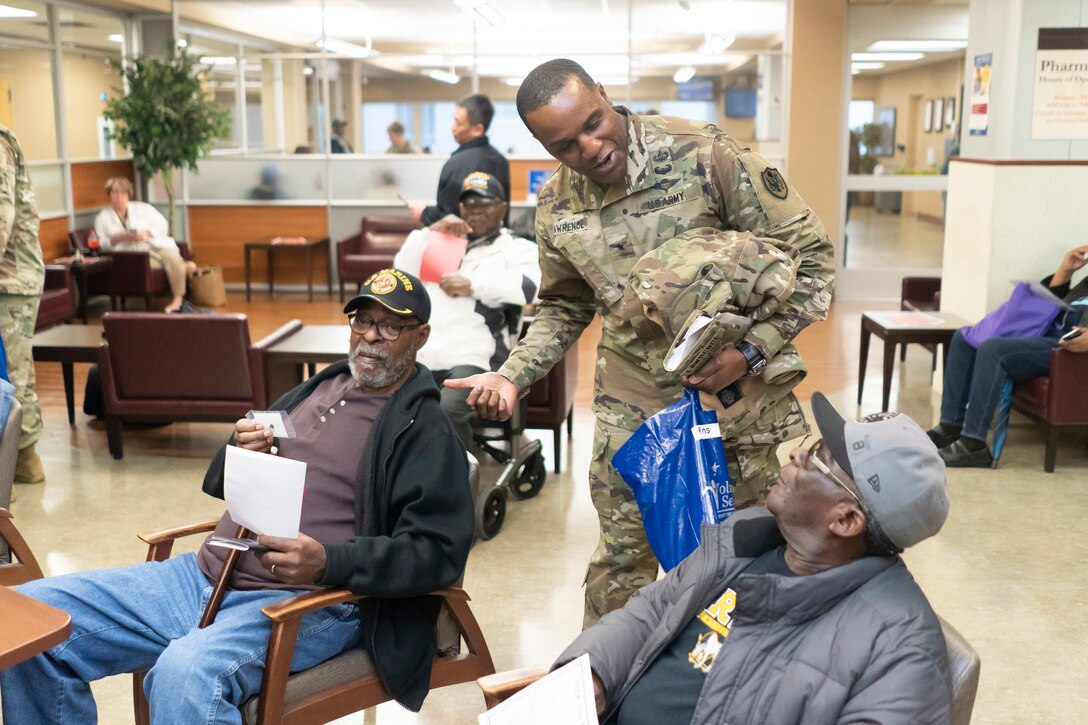 Army Brig. Gen. Gavin Lawrence, DLA Troop Support commander, speaks with a couple veteran patients at the Corporal Michael J. Crescenz Veterans Affairs Medical Center, Feb. 10, 2020 in Philadelphia.