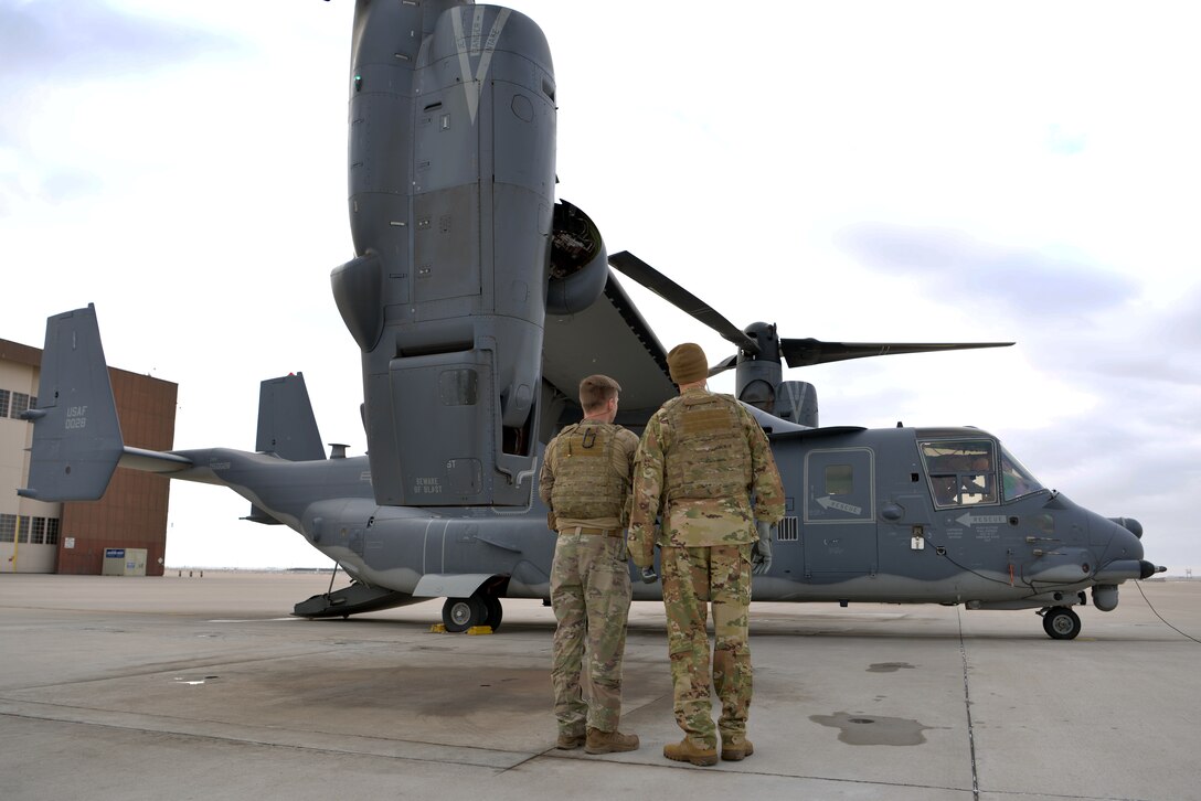 Two people looking at an aircraft