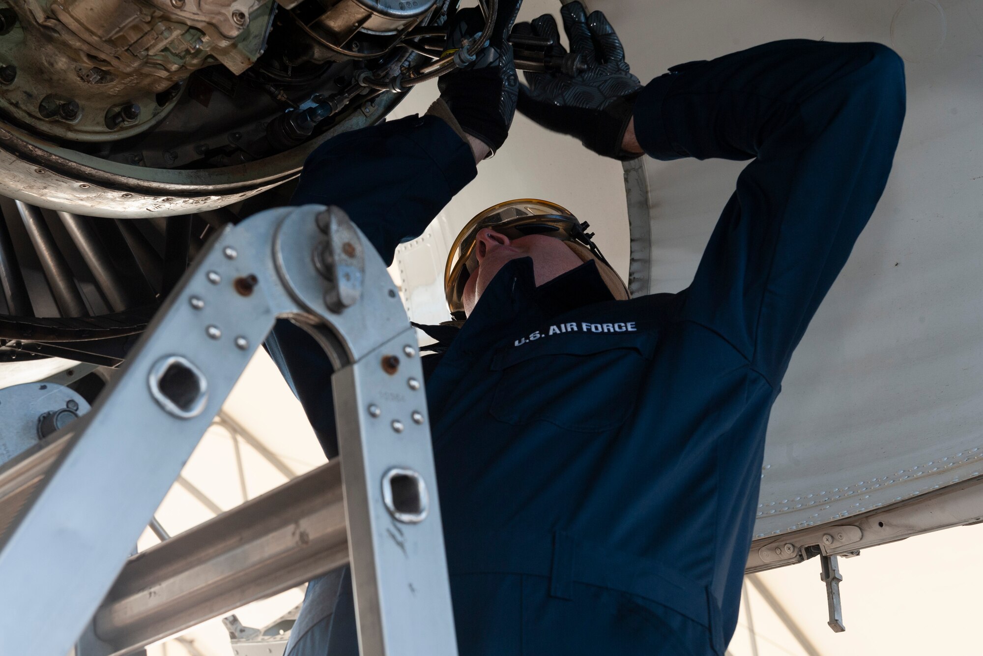 Photo of Col. Walls performing maintenance on an engine
